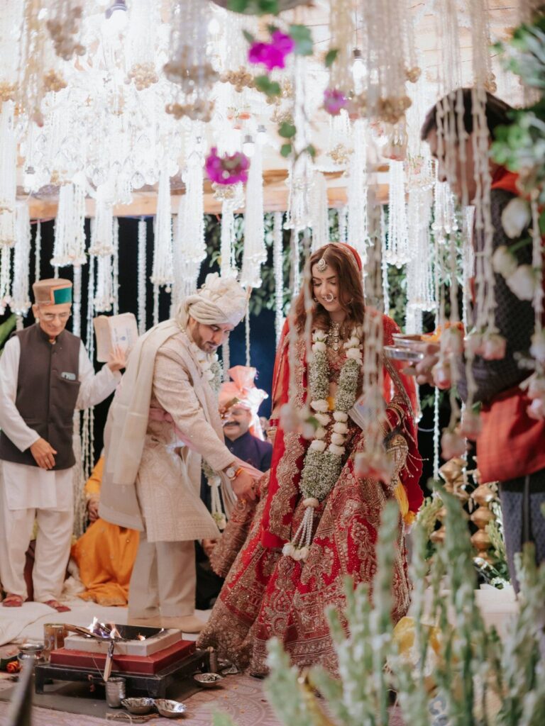 Indian bride and groom standing by a ritual fire during a wedding ceremony